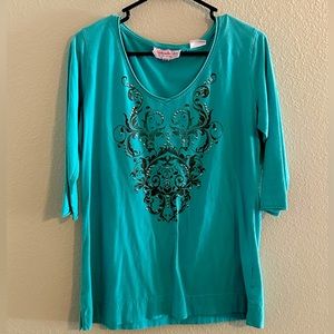 Beautiful blue southern shirt with jewels on front .